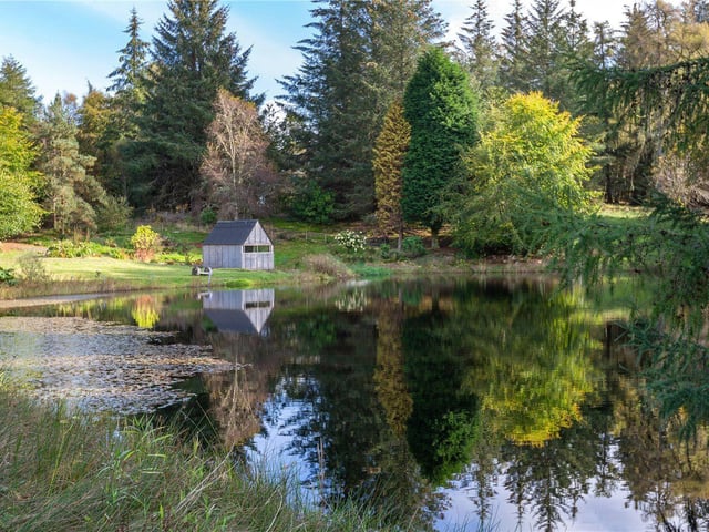 Gravel paths provide access to the different areas of the garden and to the large, well-stocked trout pond.