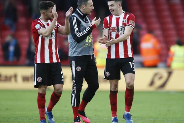 Phil Jagielka (centre) celebrates with George Baldock (left) and John Egan, following another win in the Premier League for Sheffield United: Simon Bellis/Sportimage