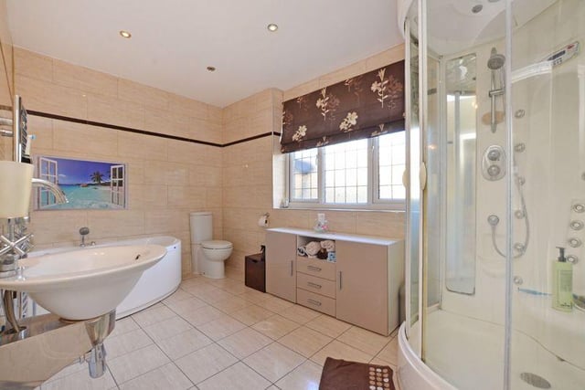 This is the en-suite linked to the master bedroom - it has a corner jacuzzi bath with shower attachment, WC, sink and shower with jacuzzi shower and is fully tiled.