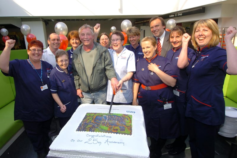 Chesterfield Royal Hospital celebrates its 25th anniversary in 2009. Trevor Bembridge, the first patient to be transferred from the old hospital, cuts the cake, watched by chairman of the hospital Richard Gregory and members of staff.