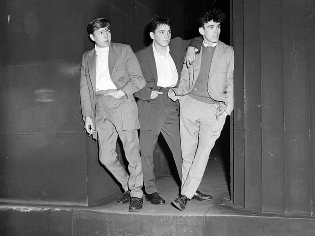 Teenagers with nothing to do on Sunday night listen to music through a portable speaker at the Mound in October 1958.