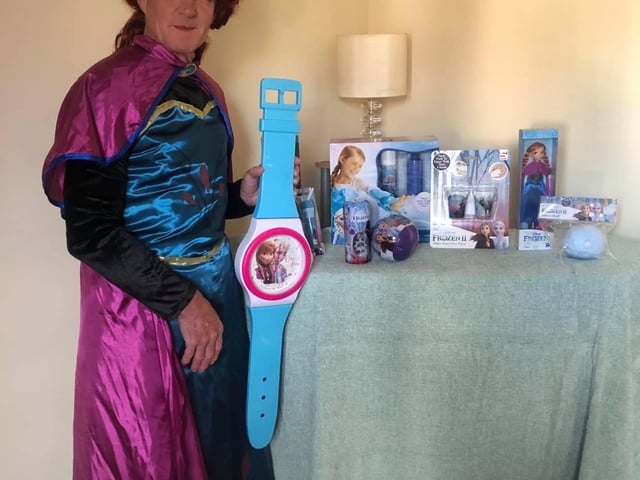 Postman David Evans with prizes for a competition he is running