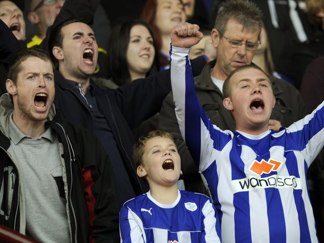 Different generations of Sheffield Wednesday fans celebrate a goal at Oakwell in 2013