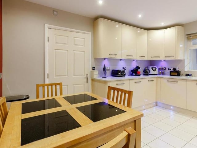 Everything about the kitchen is silky smooth. A tiled floor, ceiling spotlights, smoke alarm, radiator and large double-glazed window to the front of the bungalow complete its look.