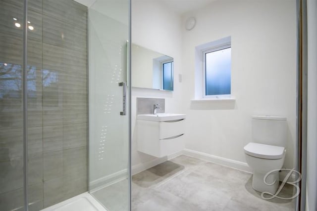 Fitted with a modern suite, shower cubicle, low level WC and wash basin set into vanity unit.