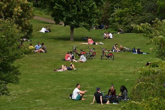 People enjoy the warm Spring temperatures (Photo by GLYN KIRK/AFP via Getty Images)