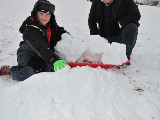 Mike Wright and his son Toryn Willis making a ramp in the snow on top of Portsdown Hill.