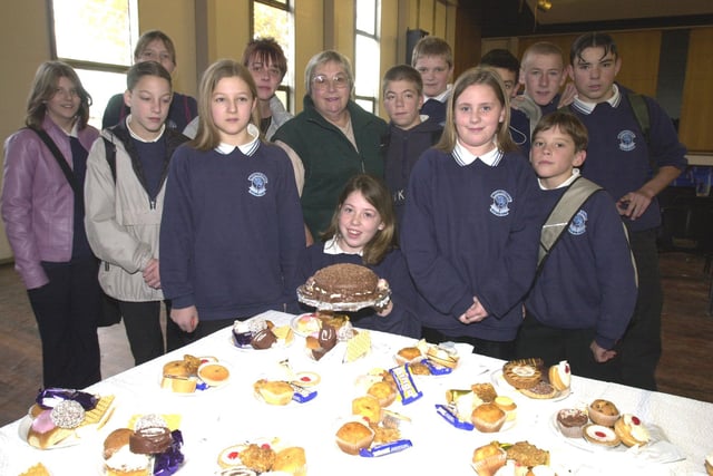Pictured at Westfield school, Mosborough, Sheffield, where a cake sale was held to raise cash for a new pair of artificial legs for pupil Jamie Leigh Griffiths who is seen in the centre with her friends around her in 2000