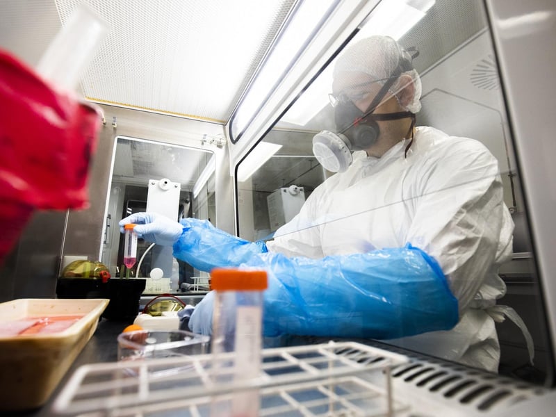 Research assistant Arthur Wickenhagen works in a Class II Microbiological Safety Cabinet growing up SARS-CoV-2, the virus which causes COVID-19, to study the virus
