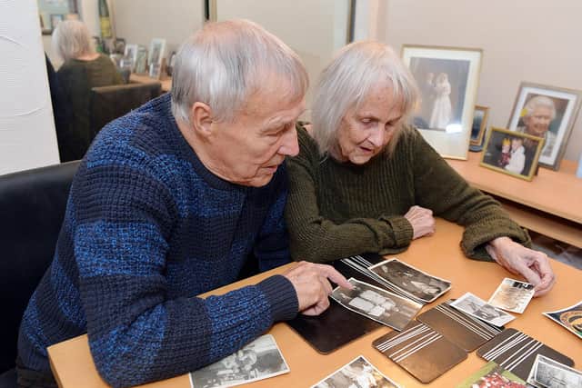 Brian and June looking throught their collection of old photos.