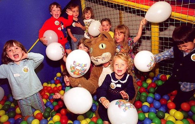 Poppy the Cat is surrounded by little children in the ball pool at the Teddyland Creche in Orchard Square in September 1996