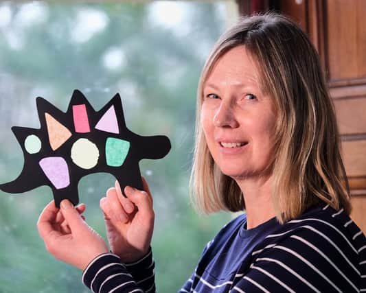 Louise Bass, learning officer for Scarborough Museums and Galleries, with a stained glass dinosaur that can be made as part of a range of workshops at the Rotunda Museum and Scarborough Art Gallery during the Easter holiday