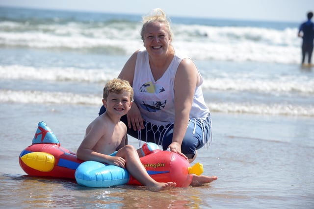 Youngster Harry Porter-Smith, six,  cools off with mother Suzanne Porter on Seaburn Beach.