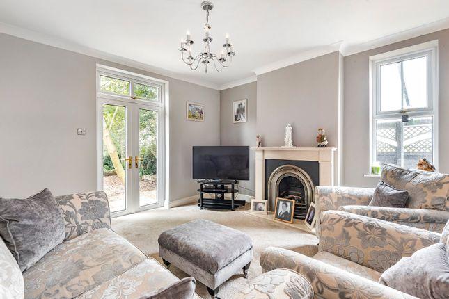 The cosy reception room features a fireplace with a coal effect gas fire with hearth and surround, coving to ceiling, a radiator, window and doors to the outside
