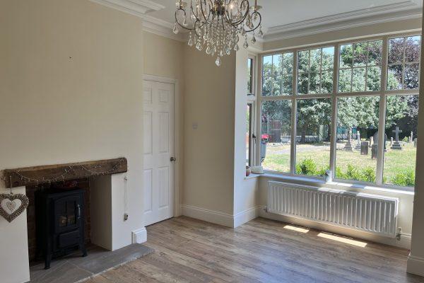 This front room is actually quite large and offers plenty of space to add a large sofa, TV, a couple of armchairs, whatever you wish really. It's large window also brings in lots and lots of natural light.