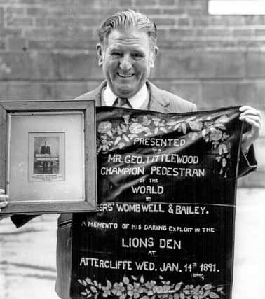 Kenneth Littlewood, with his grandfather George Littlewood's photograph and banner.