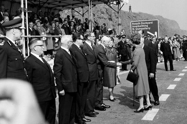 The Queen shakes hands with Sheriff Lillie in Fife while meeting some of those involved with the construction of the bridge at the opening in September 1964.