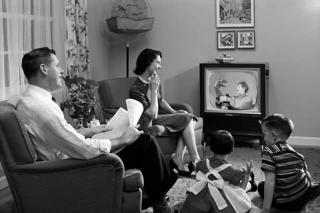 watching telly -  old fashion family watching television set tv t.v  / 1950s / historical / children / home / lounge / 