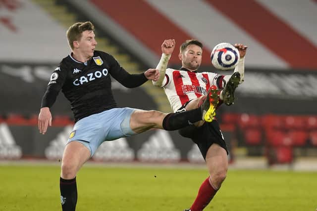 Oliver Norwood of Sheffield United tussles with Matt Targett of Aston Villa: Andrew Yates/Sportimage