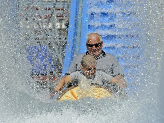 Maciej Ciarach and his grandson Alan (10) enjoy the new log flume. Picture Ian Hargreaves (180720-2)
