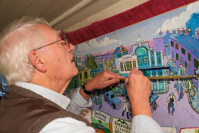 Artist Joe Scarborough working on his latest projects on his boat in Sheffield Canal Basin.