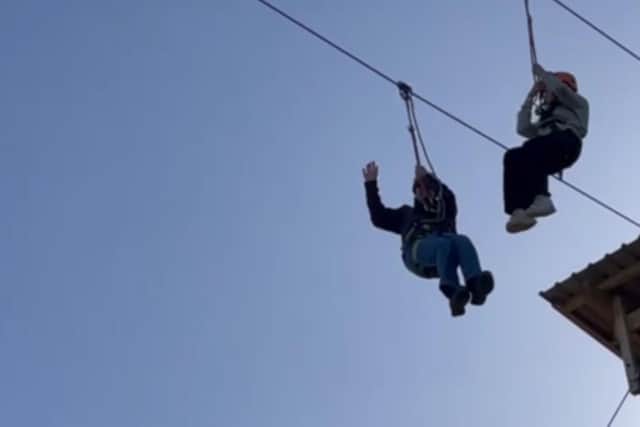 Sheffield ‘adventurer pensioner’ Barrie Grimshaw, waving, left,  has become the oldest person to hurtle along a 250m zipwire at North Yorkshire Water Park, for Sheffield Hospitals Charity