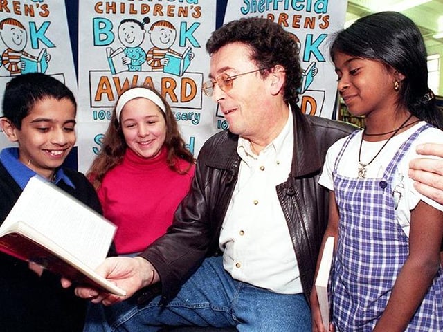 Actor Robert Powell reads to children as part of the Sheffield Children's Book Awards. The children are, left to right, Firaaz Khan, Debbie Barnard and Nazrin Akhtar, on April 30, 1998