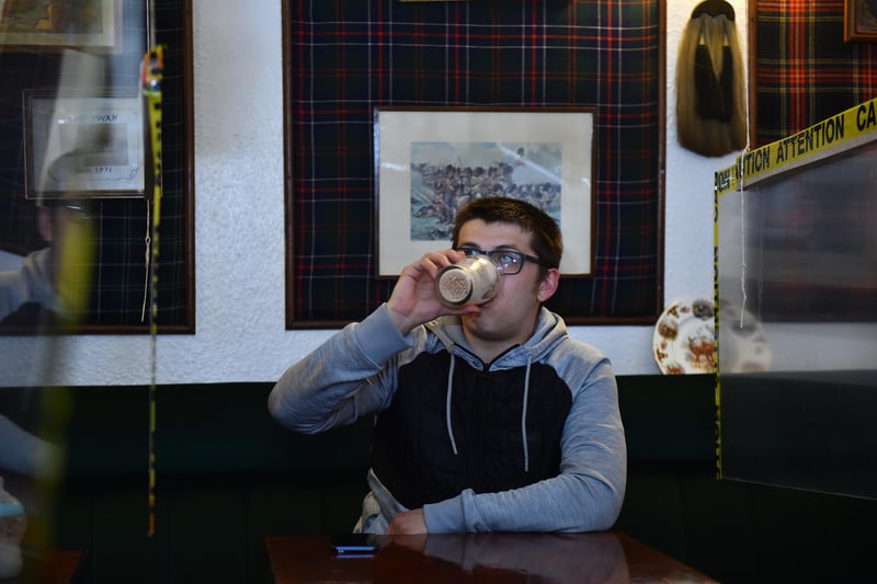 A man enjoys a drink at The Swan Inn. (Photo by Nathan Stirk/Getty Images)