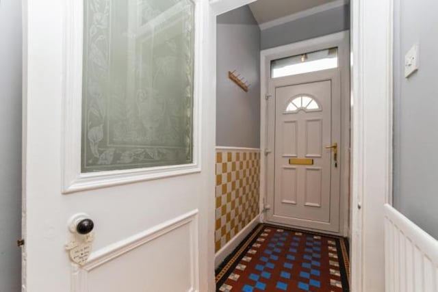 Vestibule with ornate tiled floor.