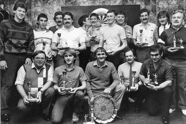 Sunderland football players Bob Bolder, left and David Hodgson, second right, hand over trophies at the Hebburn and District Darts League presentation night at Hastings Club in Hebburn. It's a scene from 1985.