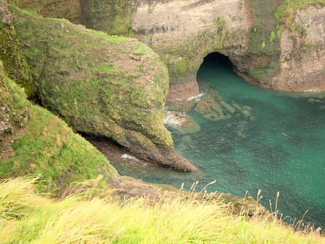 A tricky scramble gives way to a sea arch and lagoon with huge rock pools and giant sea caverns making for an exhilirating challenge for the more experienced.