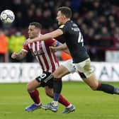 Billy Sharp of Sheffield United (L) is challenged by Kal Naismith of Luton Town: Andrew Yates / Sportimage