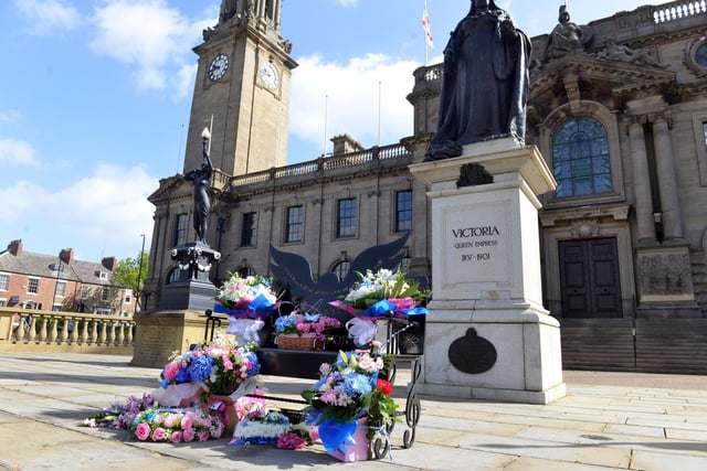 Floral tributes left on the memorial bench outside of  South Shields Town Hall.