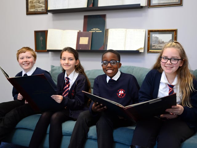 Year six children pictured taking a look at some of the old school registars dating back to 1926 in the new Intervention waiting room. Picture: NDFP-09-11-21-StAlbans 3-NMSY
