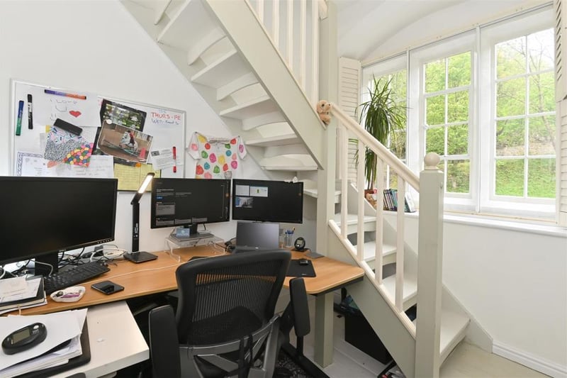 The ground-floor hallway opens out to create a splendid home office space. It is bright and airy, benefitting from the wide, tall windows to the right. There are plenty of power points, a radiator, ceiling light and fitted window shutters.