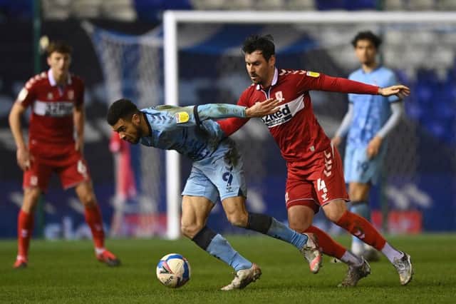 Maxime Biamou of Coventry City is challenged by Grant Hall of Middlesborough.