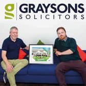 Peter Clark (left), managing partner at Graysons, holds the new design with artist Alan Pennington.