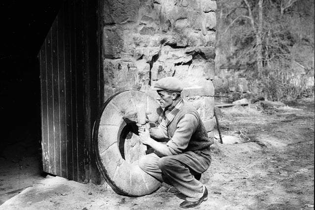 A worker repairing electric grinding stones at Redhall Flour Mill, in Colinton, pictured in March 1956.
