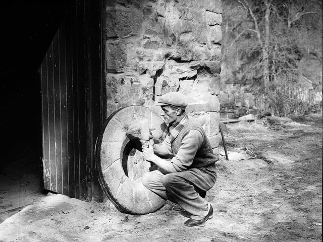 A worker repairing electric grinding stones at Redhall Flour Mill, in Colinton, pictured in March 1956.