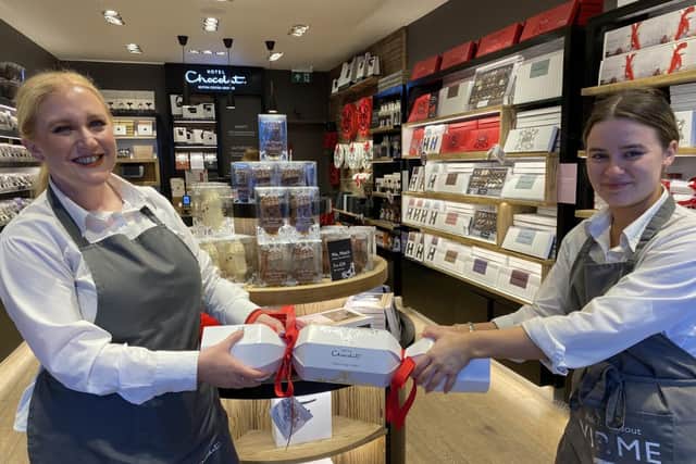 Hotel Chocolat store manager Lindsey Tierney-Quigley pulls a cracker with a staff member