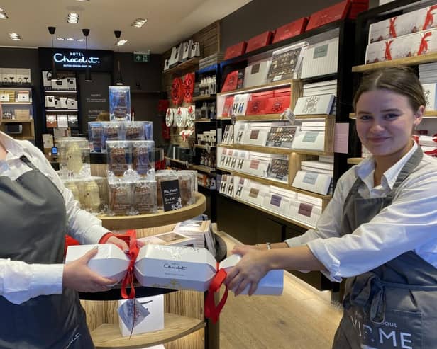 Hotel Chocolat store manager Lindsey Tierney-Quigley pulls a cracker with a staff member