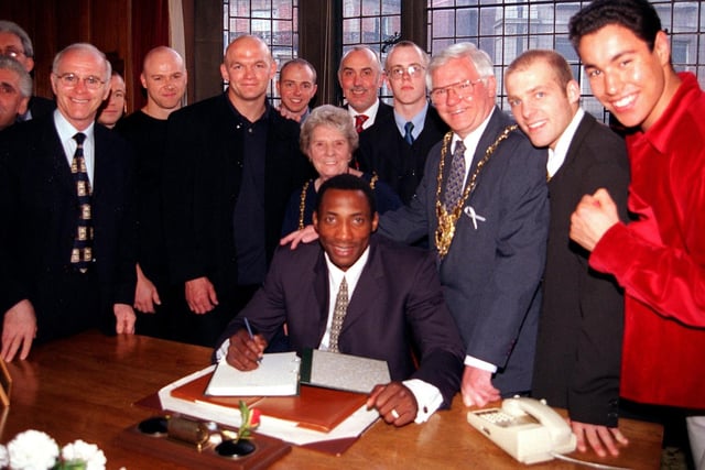 Boxer Jonny Nelson signing the visitors book at Sheffield Town Hall, during a civic reception, as the Lord Mayor of Sheffield Councillor Frank White and the Lady Mayoress Mrs Freda White look on with Brendan Ingle and some of the rising champions and friends.