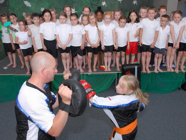 Millie Yates was watched by pupils from Sutton's Dalestorth Primary School as she demonstrated her sport of Kick Boxing with her step father Brian Slaney in 2013