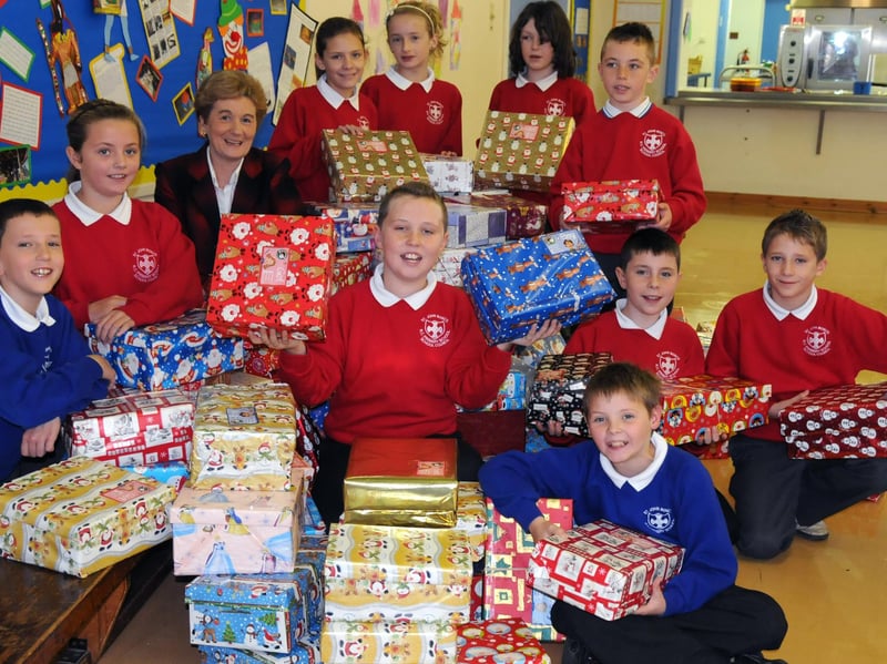 Head Teacher Anne Mackay and Council members of St John Bosco School in Sunderland with some of the 100 shoeboxes collected by the pupils in 2010.