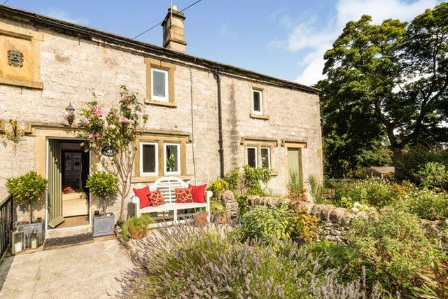This three bedroom house has gritstone fireplaces, exposed beams and mullion windows. Marketed by Bagshaws Residential, 01629 347955.