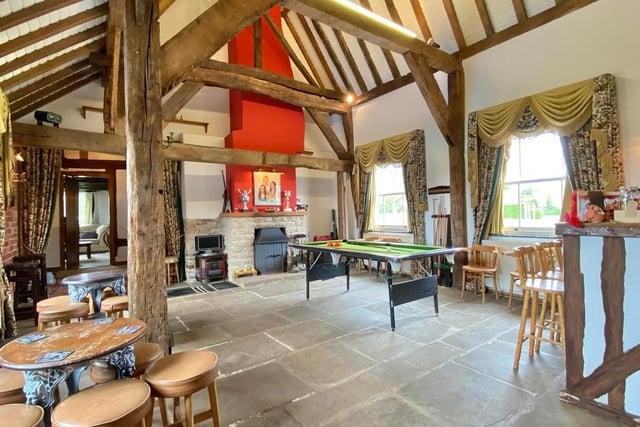 The central hall is a stunning, church-like reception room with a vaulted ceiling rising some 20 feet, flagstone flooring and exposed brickwork. There are two windows, four radiators and an open fireplace with surround stove.