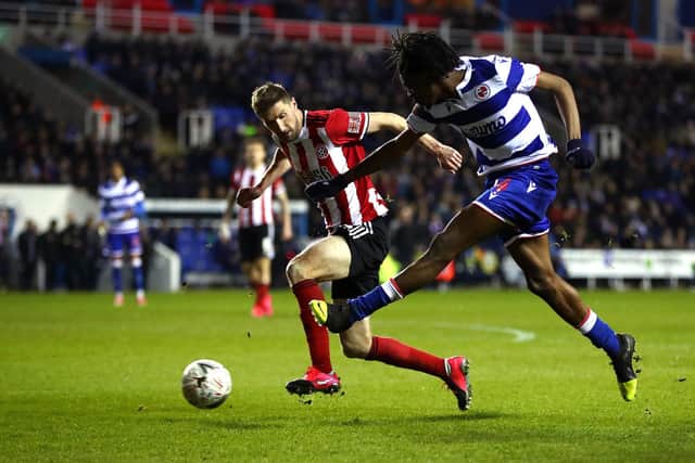 READING, ENGLAND - MARCH 03: Ovie Ejaria of Reading FC shoots past Chris Basham of Sheffield United  during the FA Cup Fifth Round match between Reading FC and Sheffield United at Madejski Stadium on March 03, 2020 in Reading, England. (Photo by Dan Istitene/Getty Images)