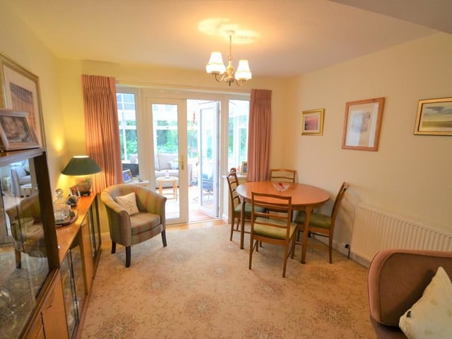 Dining room - open plan to the lounge with various power sockets, central heating radiator with thermostat and UPVC double glazed french doors open to the conservatory.