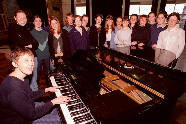 Tapton school music teacher Mrs Cowan pictured with the girls choir as they get in some practice in the school hall before taking part in a music festival in London (May 1998)
