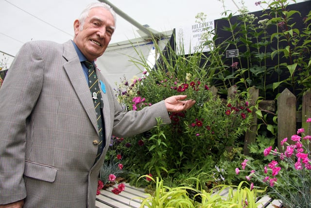 Bakewell Show Judge Gerald Treweek of Chesterfield with some of the entries in the flower show in 2011